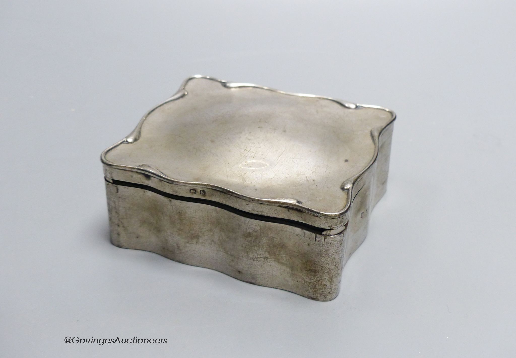A Edwardian silver jewellery box, Birmingham 1909, 11.5 cm, engraved inscription inside, and a Thai white metal and niello work compact, 6.5cm